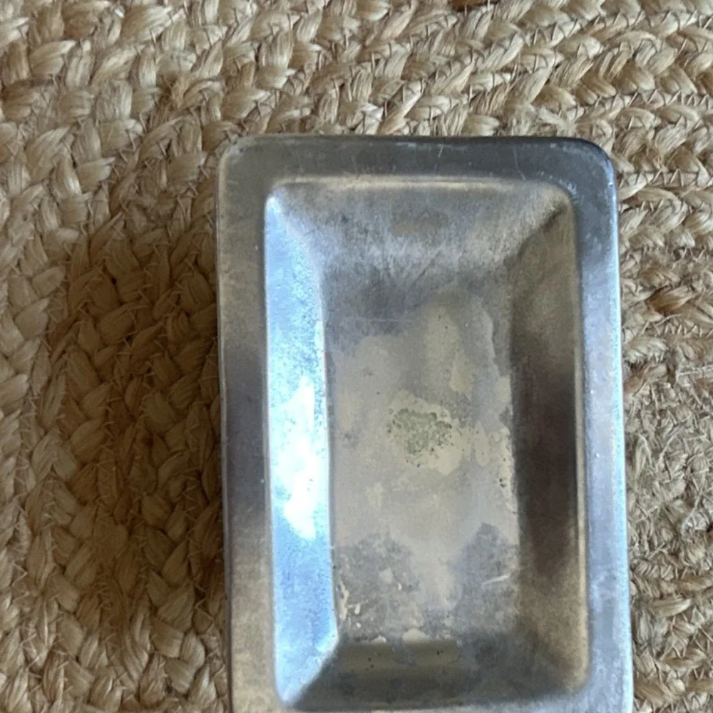 decorative silver-tone pedestal dish, likely used as a soap dish, trinket holder